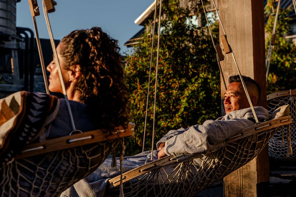 guests resting in hanging chairs