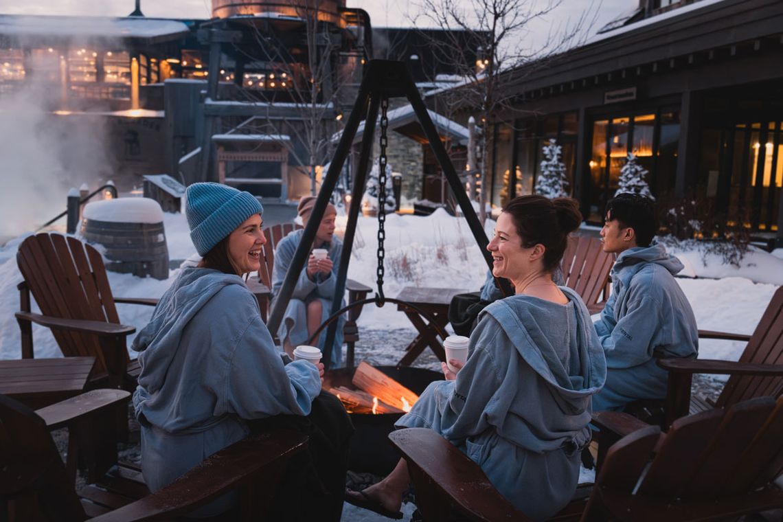 guests sitting around a fire cauldron