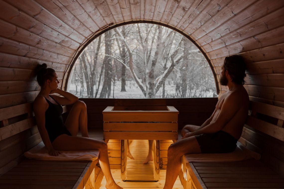 couple looking out a window in a dry sauna