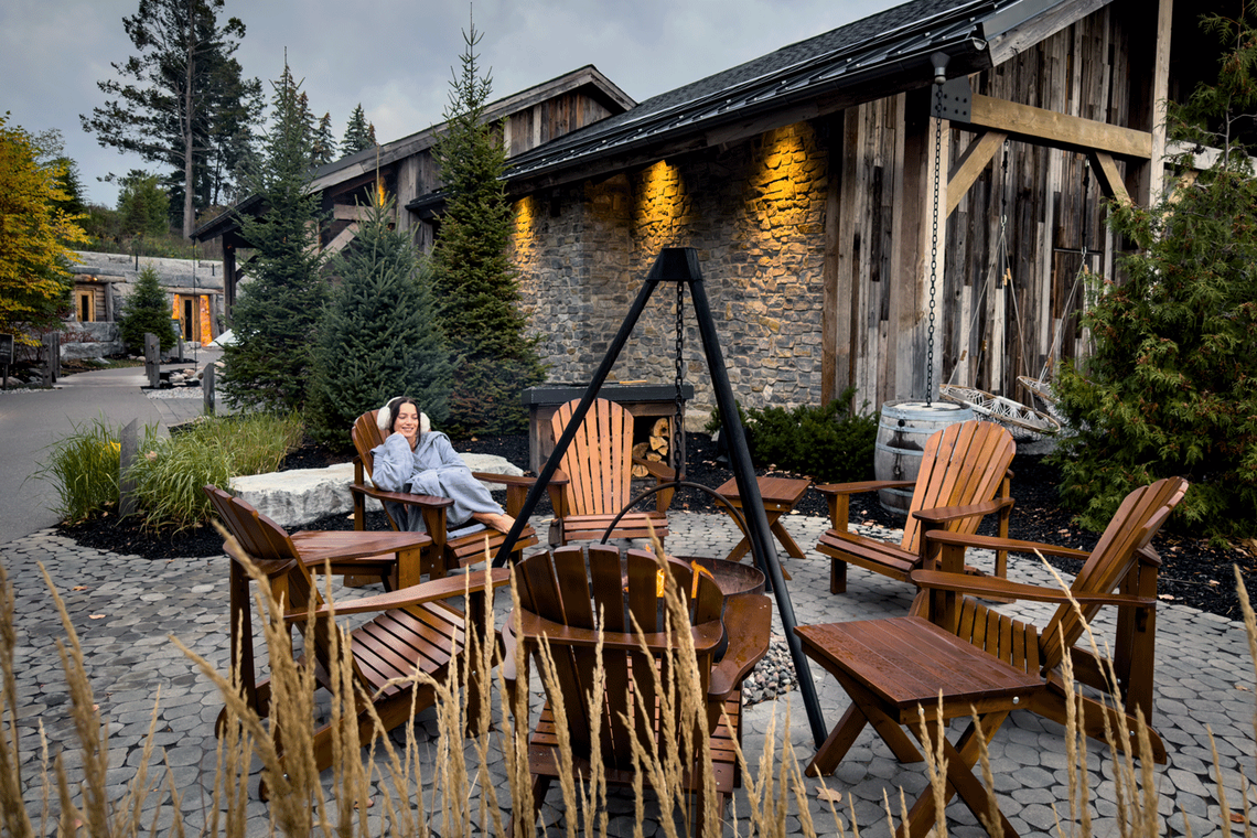 guest relaxing next to a fire cauldron
