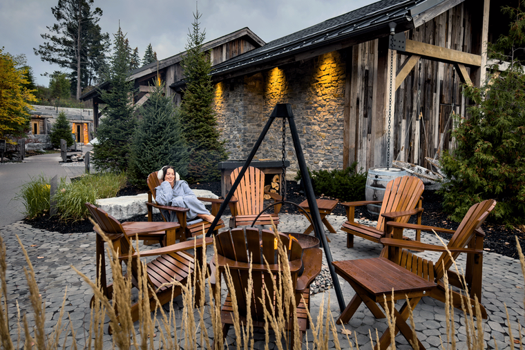 guest relaxing next to a fire cauldron