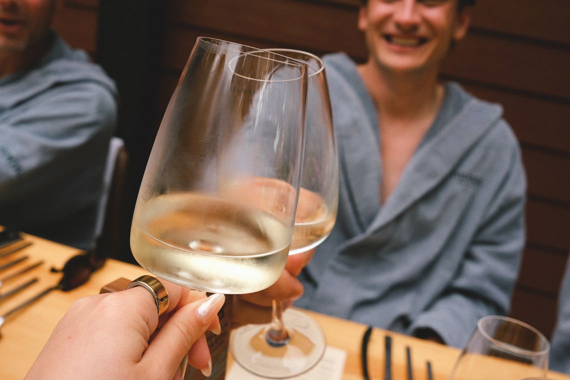 guests cheering white wine glasses at the Chef's Table event