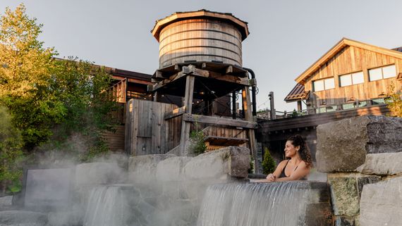 guest relaxing in a thermal bath at the Spa Village