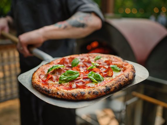 Chef Darnell presenting a pizza