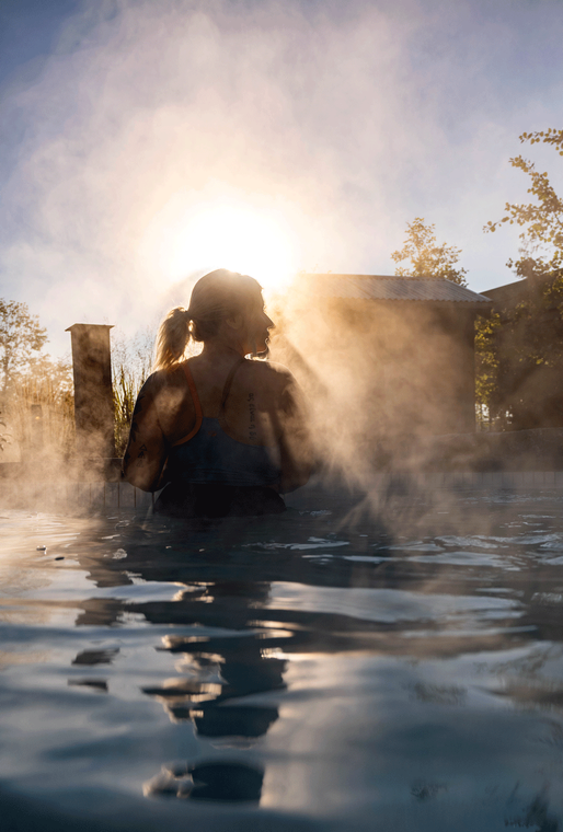 Katie surrounded by rays of light in a thermal bath