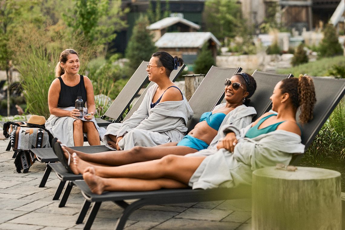 guests resting by the pond in the Spa Village